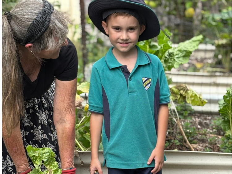 student and community member gardening