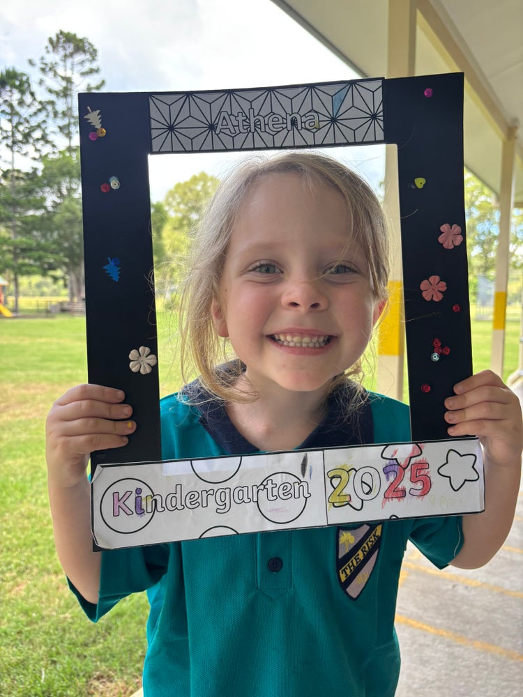 Student holding a first day of school frame