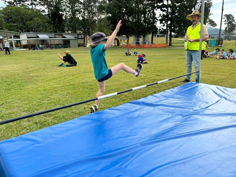 a student jumping the high jump bar