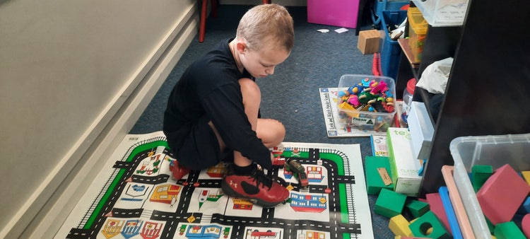 special needs student playing in classroom